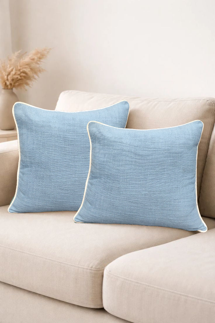 Elegant blue Floor Cushion set on a couch, perfect for enhancing home décor with a slub woven design.