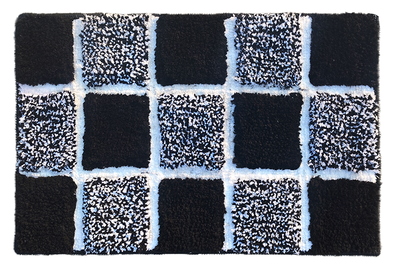 Microfiber tufted bath mat in box design, featuring black and white squares for stylish bathroom decor.